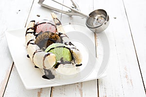 Banana split ice cream dessert with chocolate syrup