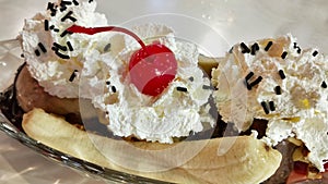 Banana split ice cream with red cherry and Whipped cream