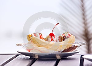 Banana split ice cream with whipped cream and cherry