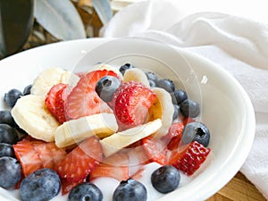 Banana Strawberry Blueberry Yogurt in White Bowl