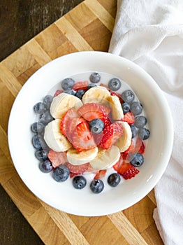 Banana Strawberry Blueberry Yogurt in White Bowl