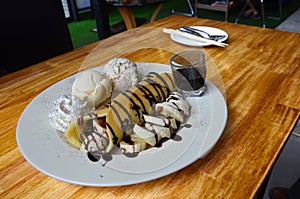 Banana waffle with ice cream and chocolate topping