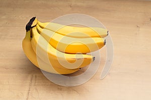 Banana on the wooden background. A banch of bananas over a wooden table