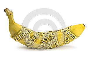 Banana wrapped with tape measure isolated on white, a concept of weight loss, healthy nutrition