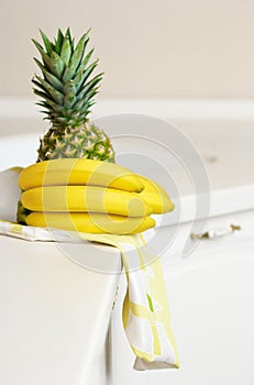 Bananas and ananas on kitchen's table