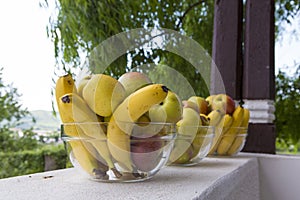 Bananas apples in a glass bole photo