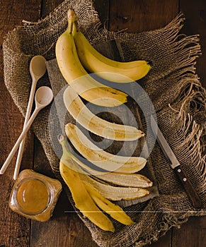 Bananas and banana slices on a wooden board