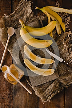 Bananas and banana slices on a wooden board