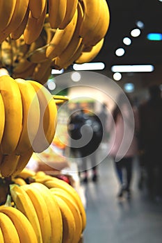Bananas and blurred image of supermarket.