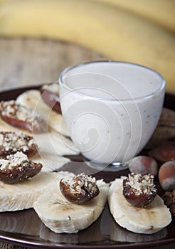 Bananas with dates and a cup of yogurt.