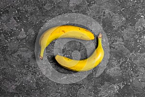 Bananas with defects on dark gray background