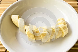 Bananas fruit slices on white plate