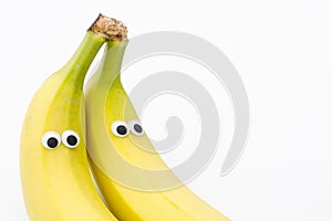 Bananas with googly eyes on white background - banana face