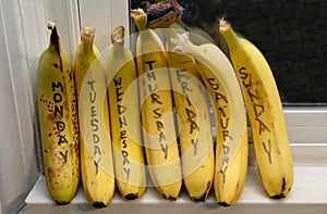 Bananas are marked with the days of the week and waiting for you to pick them up and eat them