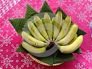 Bananas ready to be consumed on a red table mat background. photo