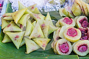 Bananas with sticky rice on green banana leaf on thai market.