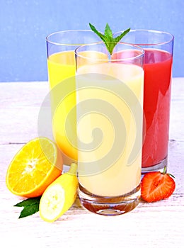 Bananas, strawberry and oranges slice, juice in glass