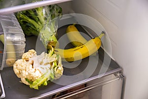 bananas and vegetables in fridge on shelf