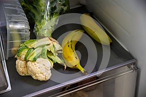 bananas and vegetables in fridge on shelf