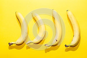 Bananas on yellow pastel background. minimal idea food concept
