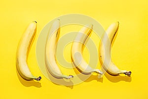 Bananas on yellow pastel background. minimal idea food concept