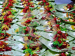 Banarasi paan or betel leaf garnished with betel nut and all indian colorful banarasi ingredients for sale photo