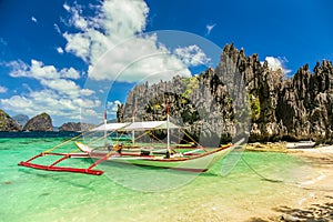 Banca boat at a beautiful beach in Miniloc Island,Philippines photo