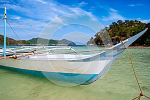 Banca boat close up on the beach of Vigan island snake Island in El nido region of Palawan in the Philippines