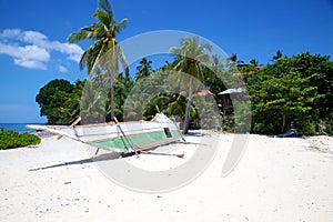 Banca boat on white sand tropical beach on Malapascua island, Philippines