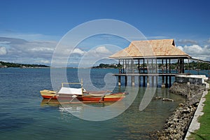 Banca Fishing boats moored off Dauis, Panglao, Bohol, Philippines with Tagbilaran in the Background photo