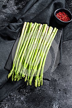 Banches of fresh green asparagus. Black background. Top view