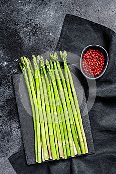 Banches of fresh green asparagus. Black background. Top view