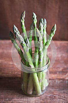 Banches of fresh green asparagus in a jar