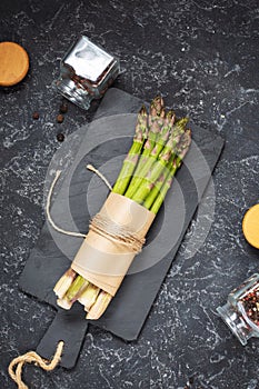 Banches of fresh green asparagus on stone background