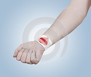 Band-aid on hand isloated on white background.