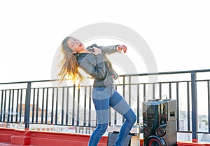 Band girl singing karaoke outdoor at roof terrace