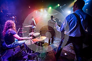 Band performs on stage in a nightclub