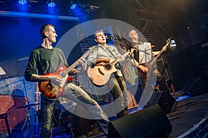 Band performs on stage, rock music concert in a nightclub photo