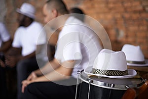 Band, relax and music with percussion drums on stage, rhythm and men with talent in group. Friends, hats and practice