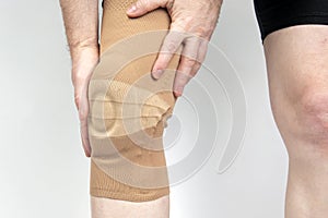 Bandage for fixing the injured knee of the human leg on a white background. medicine and sports. limb injury treatment