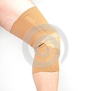 Bandage for fixing the injured knee of the human leg on a white background. medicine and sports. limb injury treatment