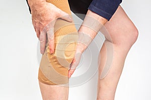 Bandage for fixing the injured knee of the human leg on a white background. medicine and sports. limb injury treatment