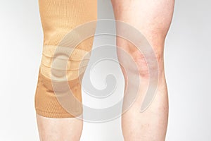 bandage for fixing the injured knee of the human leg on a white background. medicine and sports. limb injury treatment