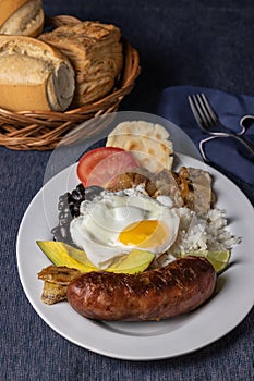 Bandeja paisa, typical food of Colombia with beans, rice, eggs and pork photo