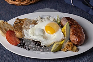 Bandeja paisa, typical food of Colombia in white plate photo