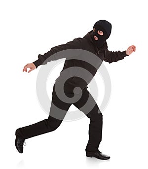 Bandit in black mask running away