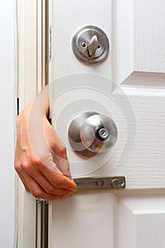 Bandit hand try to open chain lock and knob lock in door