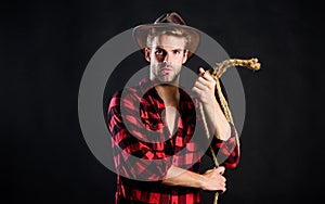 Is he bandit. western cowboy portrait. man checkered shirt on ranch. Vintage style man. Wild West retro cowboy. cowboy