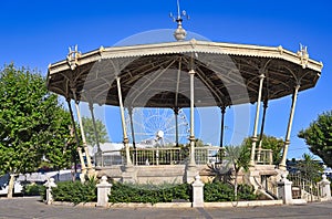 A bandstand and ferris wheel in Cannes city France photo