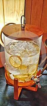 Glass jar with orange infused ice water photo